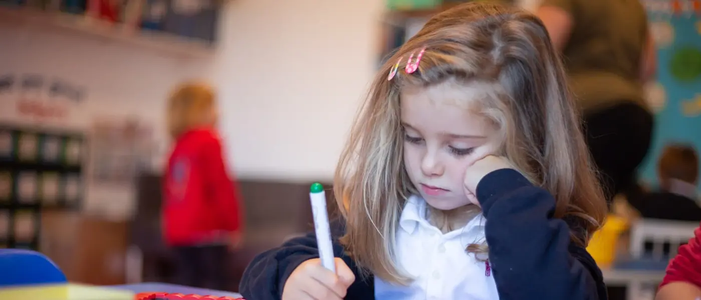 H-IS student writes in class