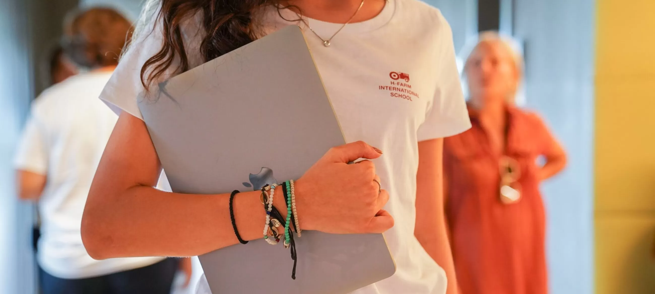 H-FARM student carrying a laptop